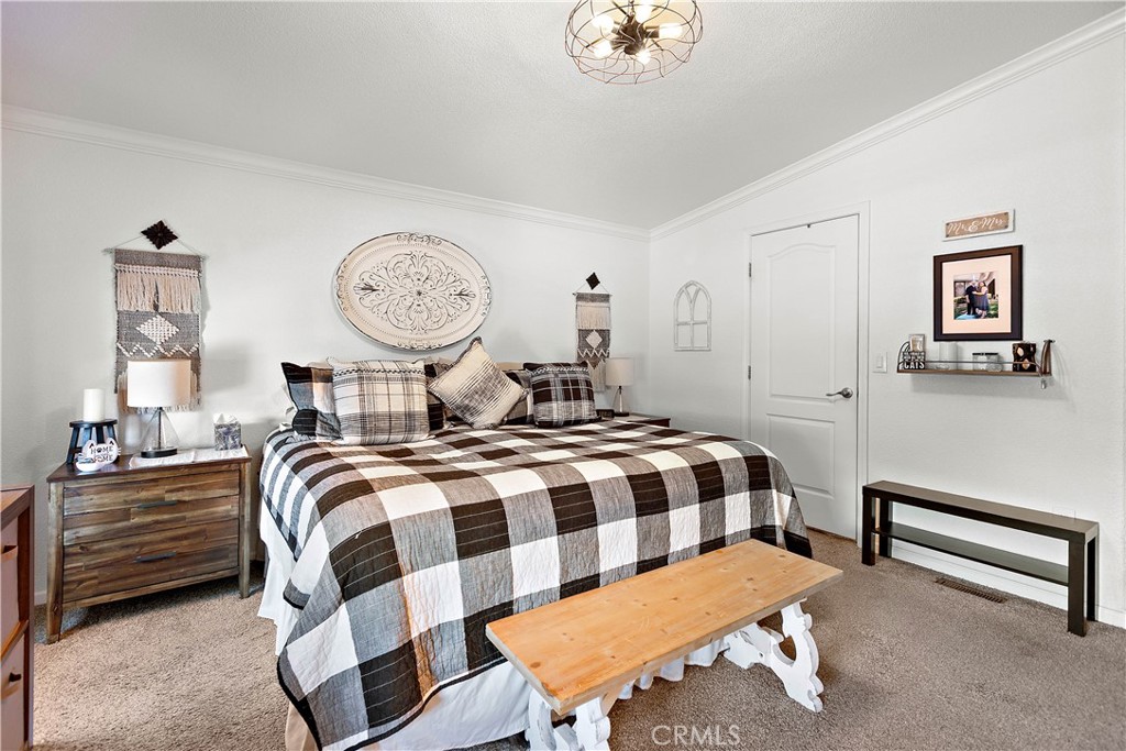 8651 Foothill Boulevard, Unit 82 Rancho Cucamonga, CA 91730 - Photo 35 of 56 a bedroom with a bed and a lamp on dresser