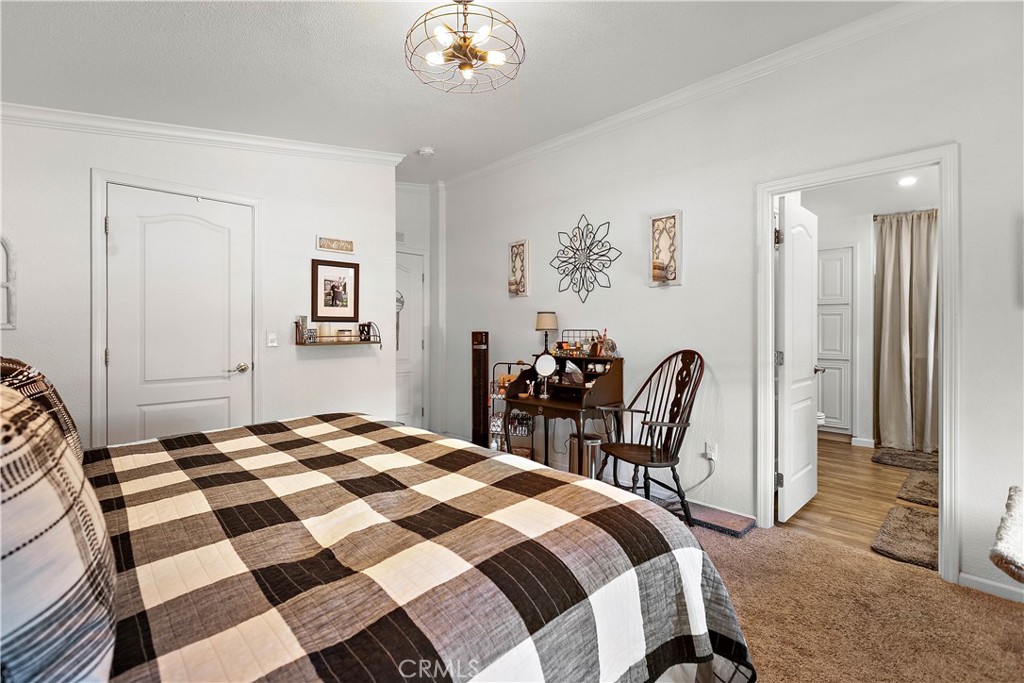 8651 Foothill Boulevard, Unit 82 Rancho Cucamonga, CA 91730 - Photo 36 of 56 a bedroom with a bed and a table with chair