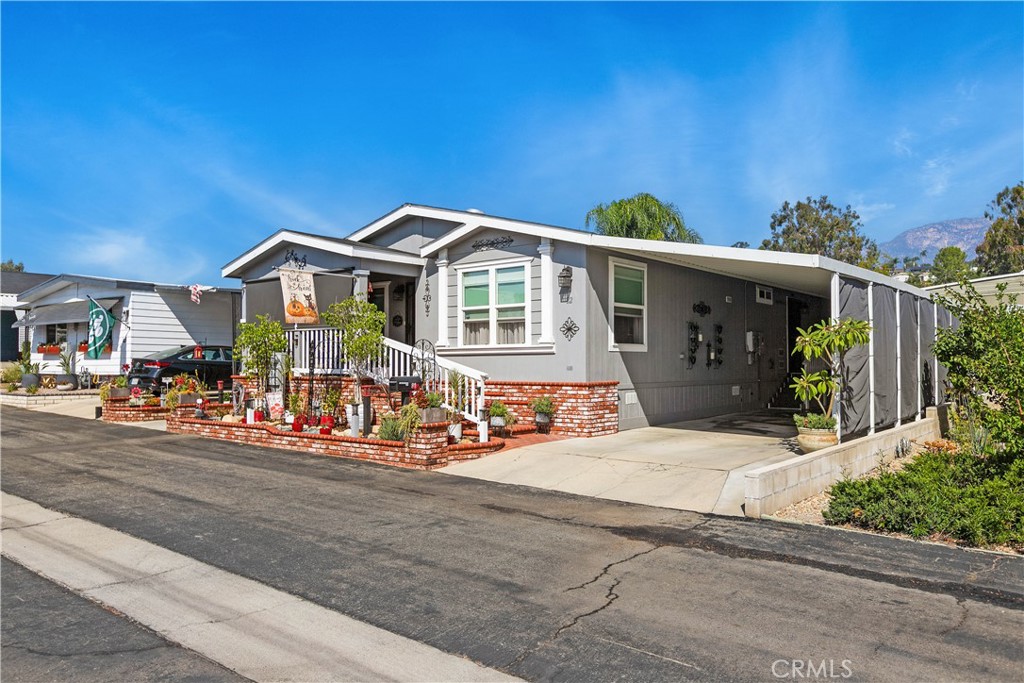 8651 Foothill Boulevard, Unit 82 Rancho Cucamonga, CA 91730 - Photo 6 of 56 a front view of a house with garage