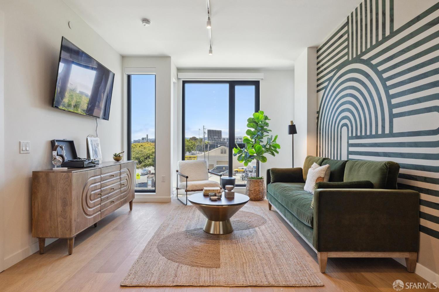 988 Harrison Street, Unit WE2 San Francisco, CA 94107 - Photo 1 of 18 a living room with furniture and a potted plant