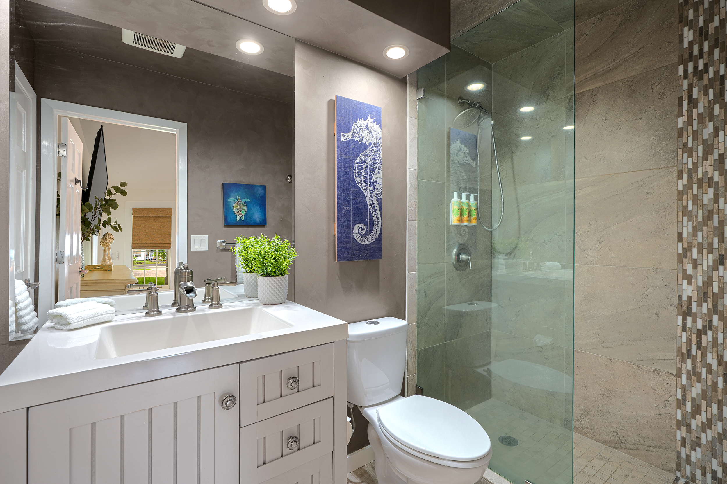 5348 Honoiki Road Princeville, HI 96722 - Photo 21 of 25 a bathroom with a double vanity sink toilet and shower