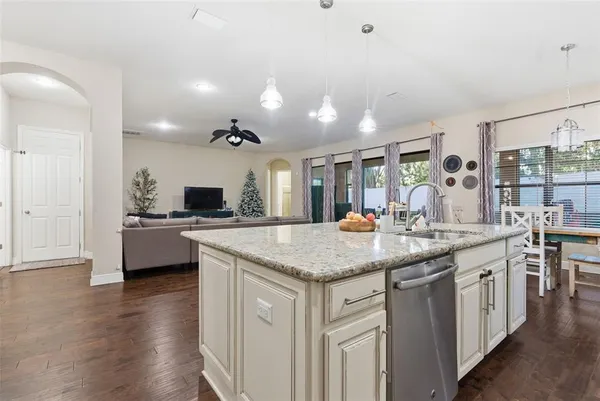 a kitchen with stainless steel appliances granite countertop a sink and cabinets