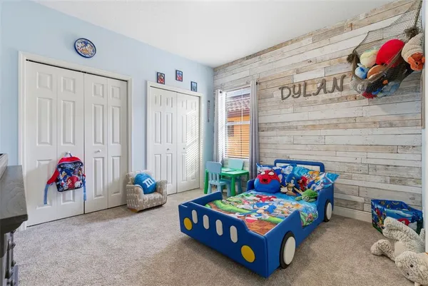 a bedroom with furniture and a baby crib
