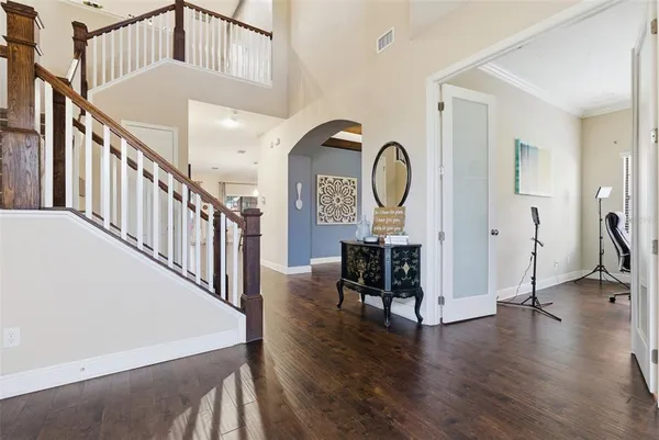 a view of a hallway with wooden floor and entryway