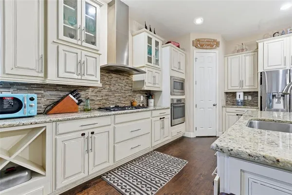 a kitchen with stainless steel appliances granite countertop a sink and cabinets