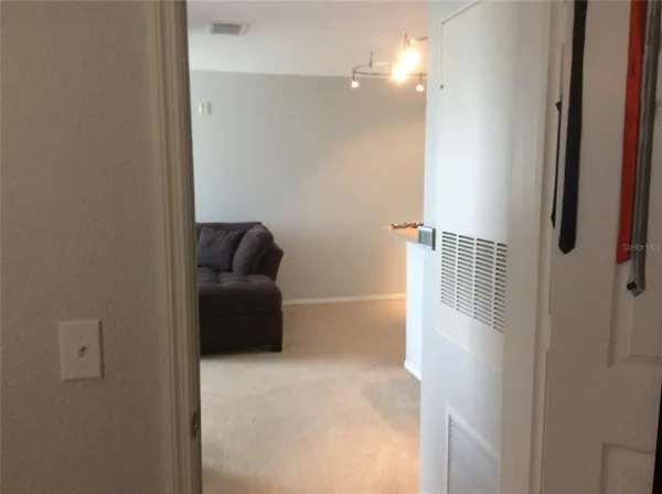 a living room with furniture and a lamp