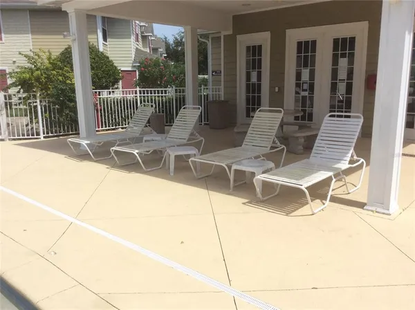 a building outdoor space with patio furniture and garden