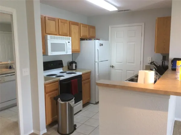 a kitchen with refrigerator and window