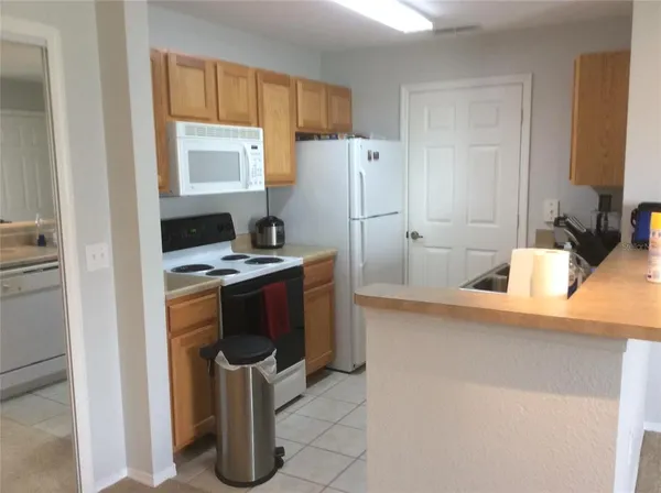 a kitchen with refrigerator and window
