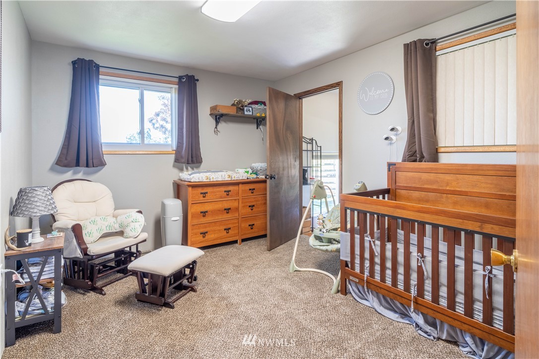 512 Rd P Northeast Moses Lake, WA 98837 - Photo 16 of 39 a bedroom with furniture and a window