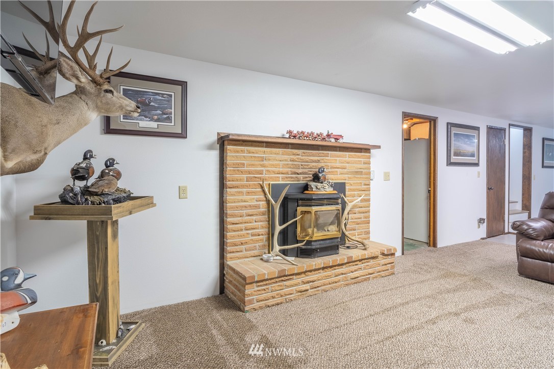 512 Rd P Northeast Moses Lake, WA 98837 - Photo 22 of 39 a living room with furniture and a fireplace