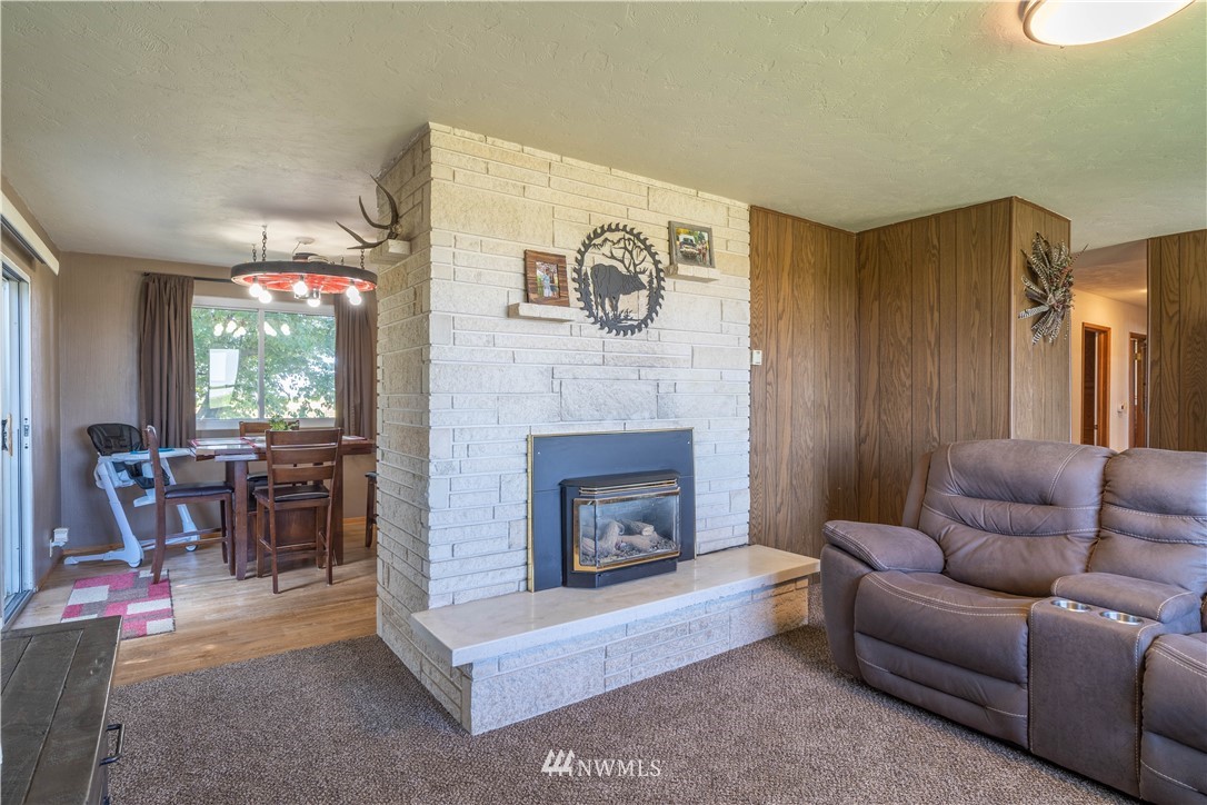 512 Rd P Northeast Moses Lake, WA 98837 - Photo 5 of 39 a living room with furniture and a fireplace