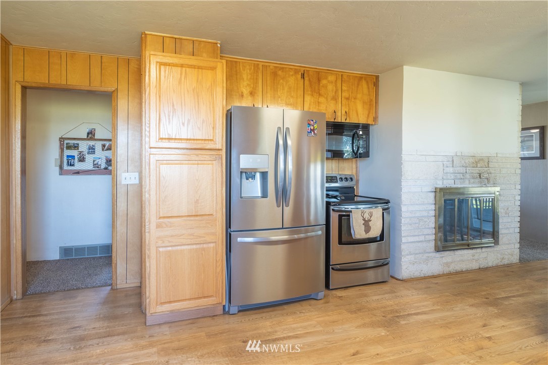 512 Rd P Northeast Moses Lake, WA 98837 - Photo 7 of 39 a kitchen with stainless steel appliances granite countertop a refrigerator and a stove