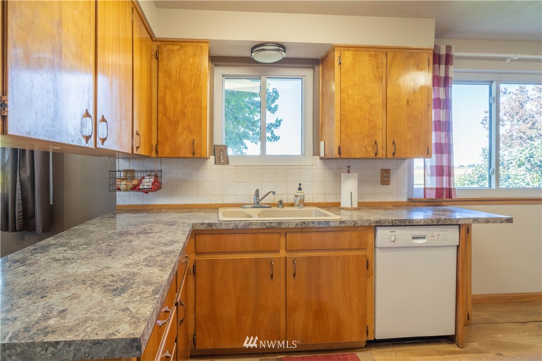512 Rd P Northeast Moses Lake, WA 98837 - Photo 8 of 39 a kitchen with wooden cabinets a sink and a window