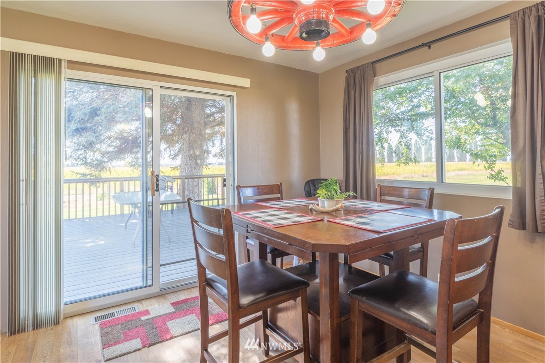512 Rd P Northeast Moses Lake, WA 98837 - Photo 10 of 39 a view of a dining room with furniture large windows and wooden floor