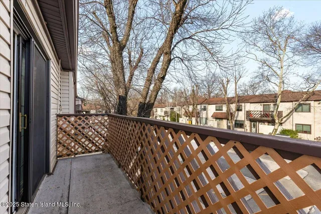 a view of a balcony with trees