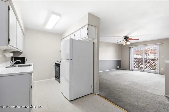 a view of a kitchen with a sink and cabinet area