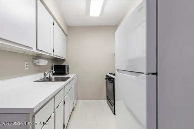 a kitchen with a sink and a refrigerator