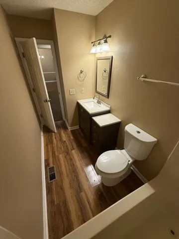 a bathroom with a toilet sink and mirror