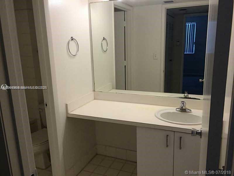 761 North Pine Island Road, Unit 203 Plantation, FL 33324 - Photo 6 of 11 a bathroom with a sink and a mirror