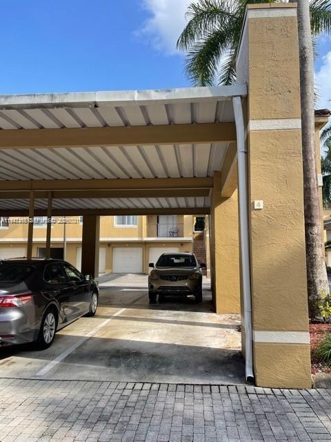 761 North Pine Island Road, Unit 203 Plantation, FL 33324 - Photo 10 of 11 a view of a car parked in the parking area