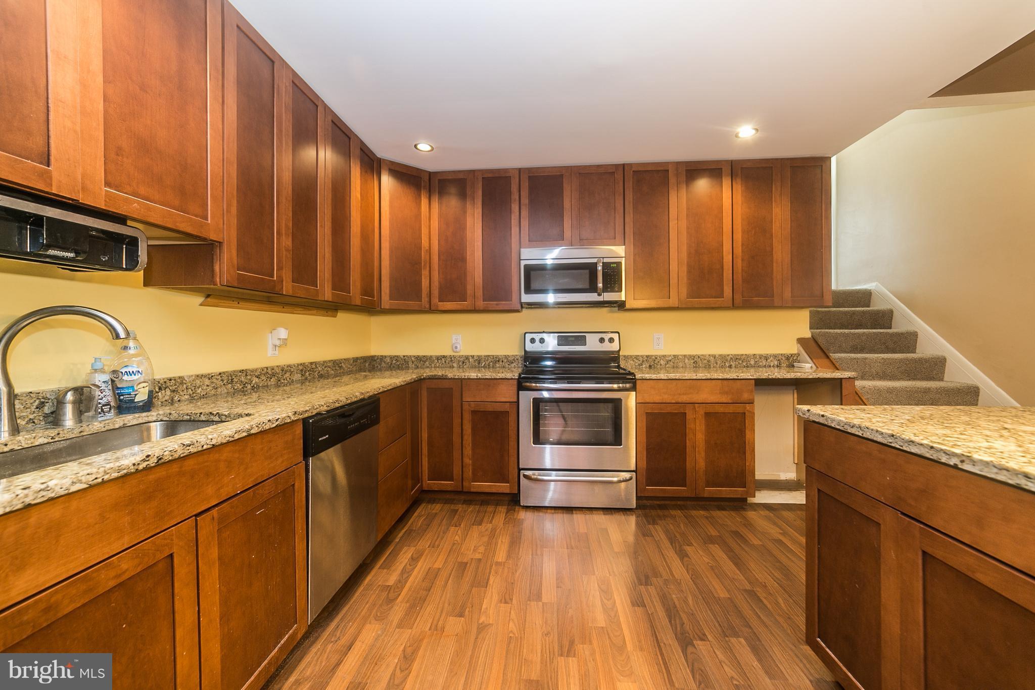 209 Redbud Road Edgewood, MD 21040 - Photo 11 of 30 a kitchen with kitchen island granite countertop a sink cabinets and stainless steel appliances
