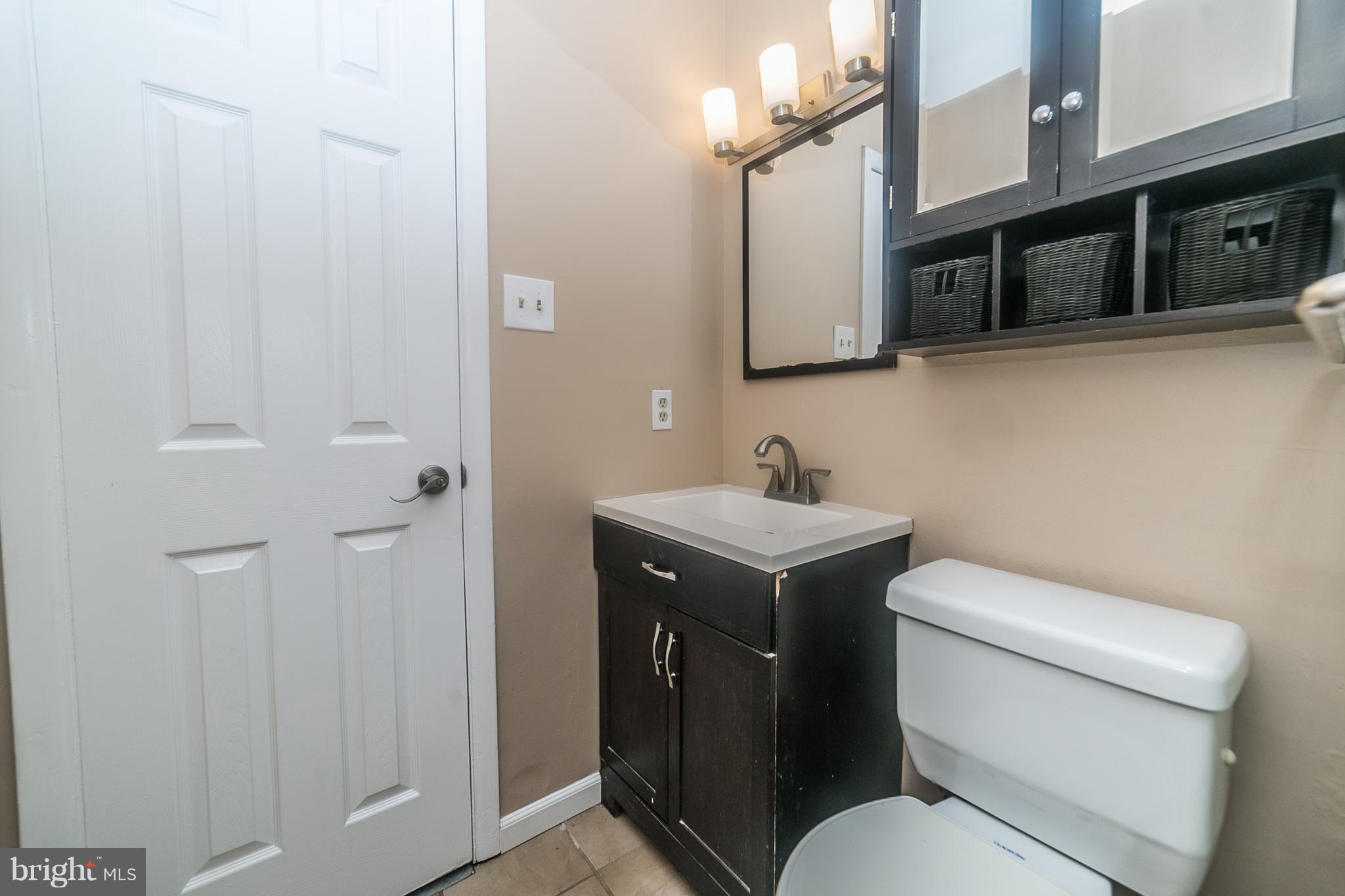 209 Redbud Road Edgewood, MD 21040 - Photo 19 of 30 a bathroom with a toilet sink and mirror