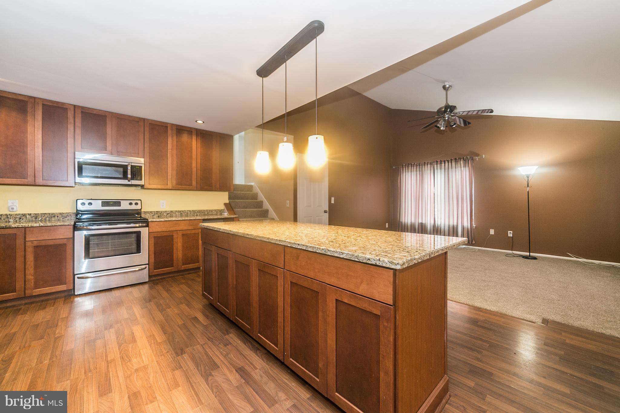 209 Redbud Road Edgewood, MD 21040 - Photo 8 of 30 a kitchen with stainless steel appliances kitchen island granite countertop a stove a sink and a refrigerator