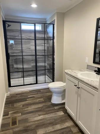 a bathroom with a sink toilet and shower