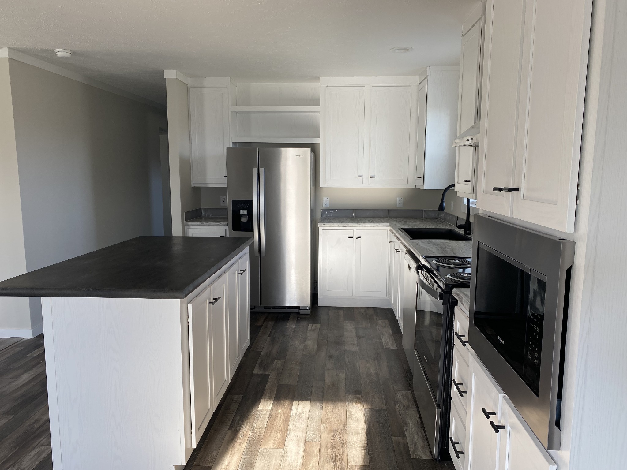 1668 Gamaliel Road Red Boiling Springs, TN 37150 - Photo 7 of 25 a kitchen with granite countertop a sink stove and refrigerator