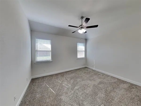 an empty room with a empty space and a ceiling fan