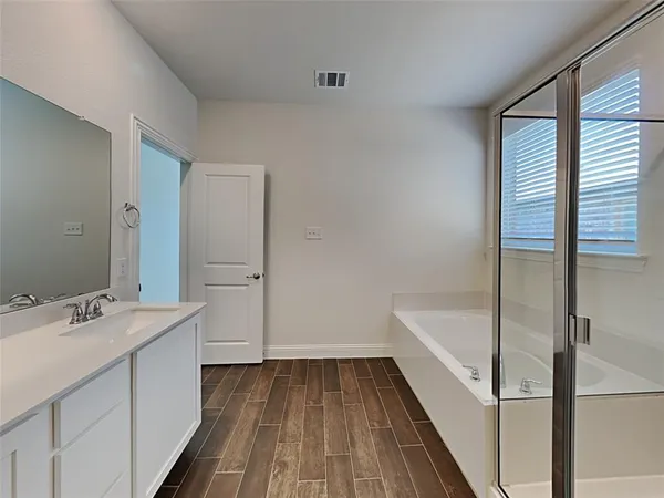 a bathroom with a sink a mirror and a bathtub