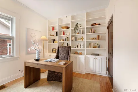 a view of room with guitars and wooden floor
