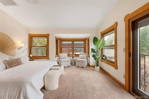 a spacious bedroom with a large bed and a large window with outer view