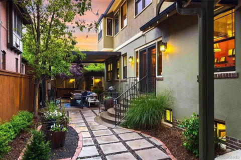 a view of a house with sitting area and garden