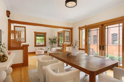 a dining room with wooden floor and a window