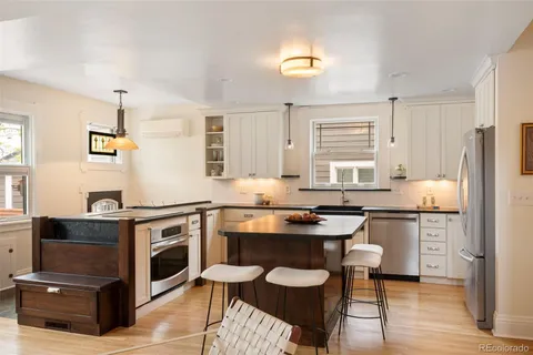 a kitchen with a stove a sink and a refrigerator