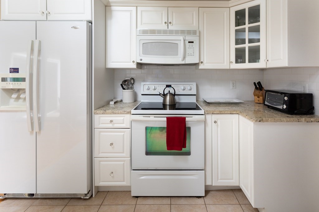 329 White Oak Trail Barnstable, MA 02632 - Photo 21 of 38 a kitchen with stainless steel appliances cabinets and a window