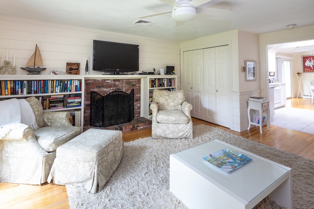 329 White Oak Trail Barnstable, MA 02632 - Photo 24 of 38 a living room with furniture a flat screen tv and a fireplace