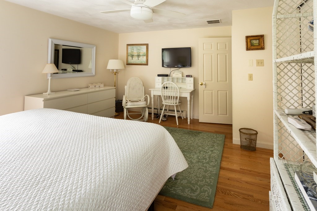 329 White Oak Trail Barnstable, MA 02632 - Photo 28 of 38 a bedroom with a bed and a flat screen tv