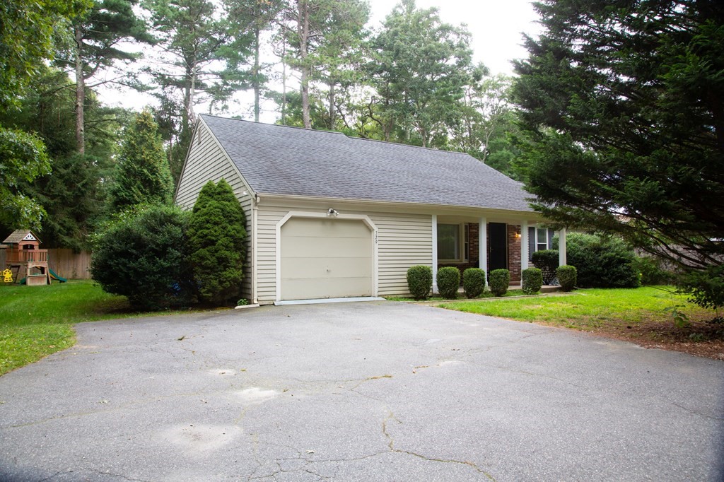 329 White Oak Trail Barnstable, MA 02632 - Photo 3 of 38 a front view of a house with a yard and garage
