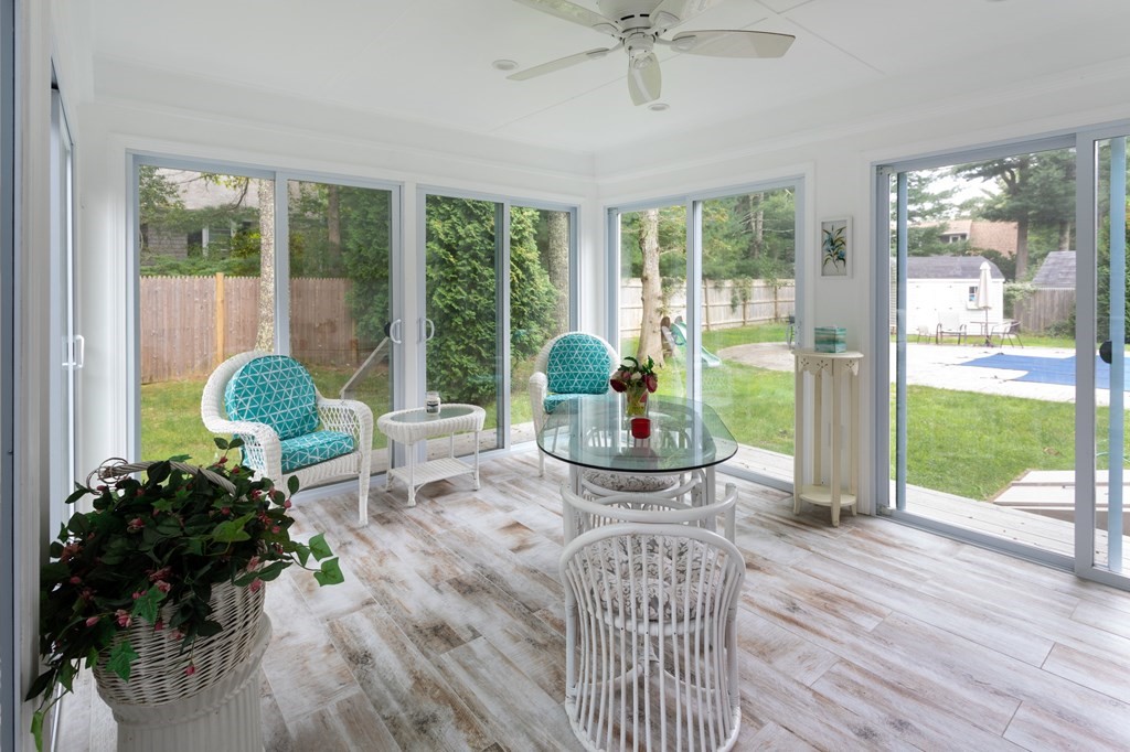 329 White Oak Trail Barnstable, MA 02632 - Photo 31 of 38 a living room filled with furniture and a floor to ceiling window