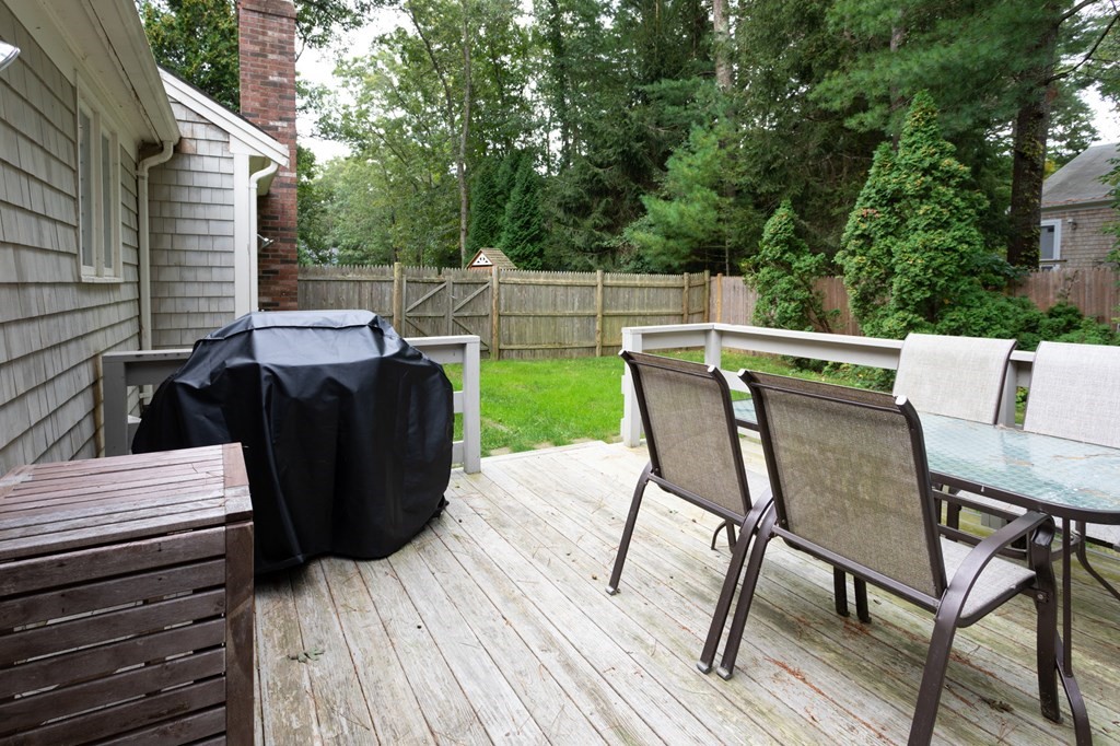 329 White Oak Trail Barnstable, MA 02632 - Photo 33 of 38 a view of deck with table and chairs and wooden floor