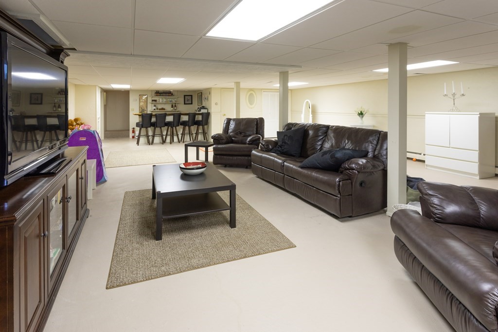 329 White Oak Trail Barnstable, MA 02632 - Photo 35 of 38 a living room with furniture and a flat screen tv