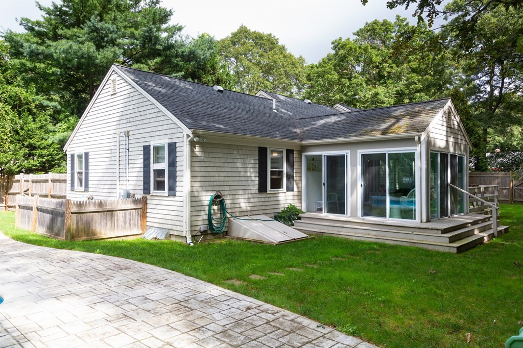 329 White Oak Trail Barnstable, MA 02632 - Photo 10 of 38 a front view of house with a garden and patio