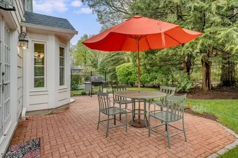 a patio with a yard table and chairs