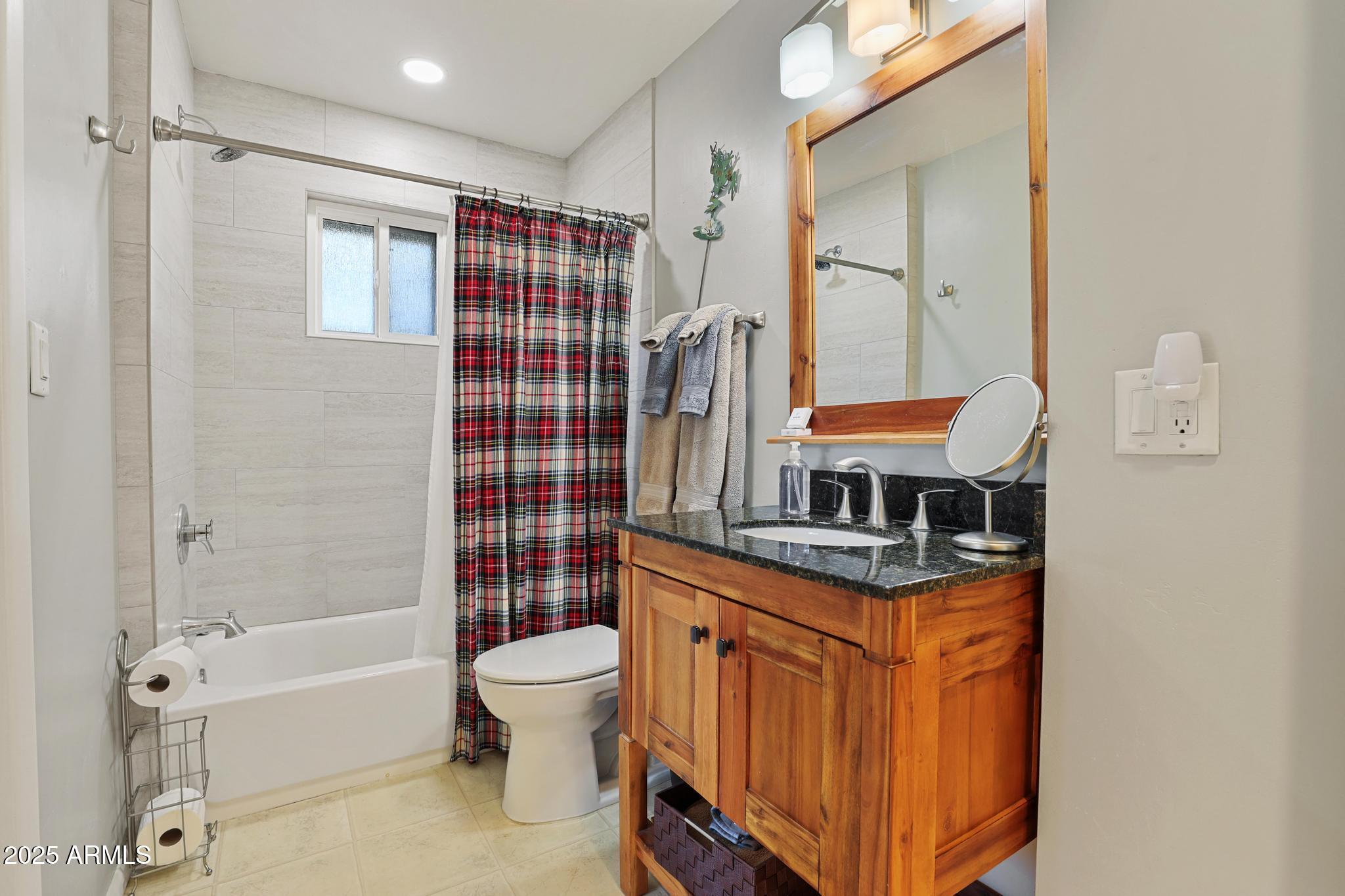 4744 Charles Circle Strawberry, AZ 85544 - Photo 16 of 39 a bathroom with a granite countertop sink toilet and shower