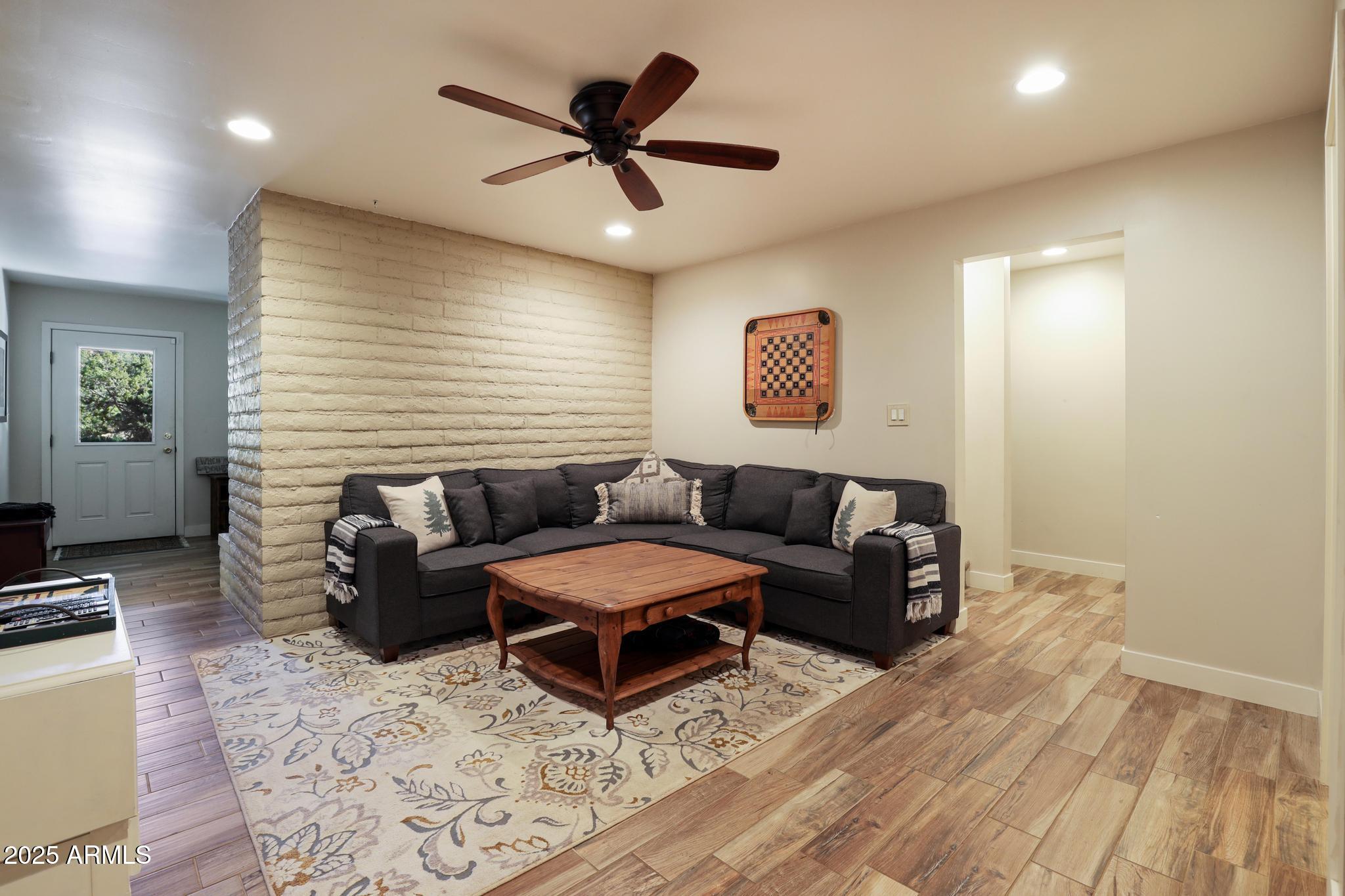 4744 Charles Circle Strawberry, AZ 85544 - Photo 21 of 39 a living room with furniture and a wooden floor