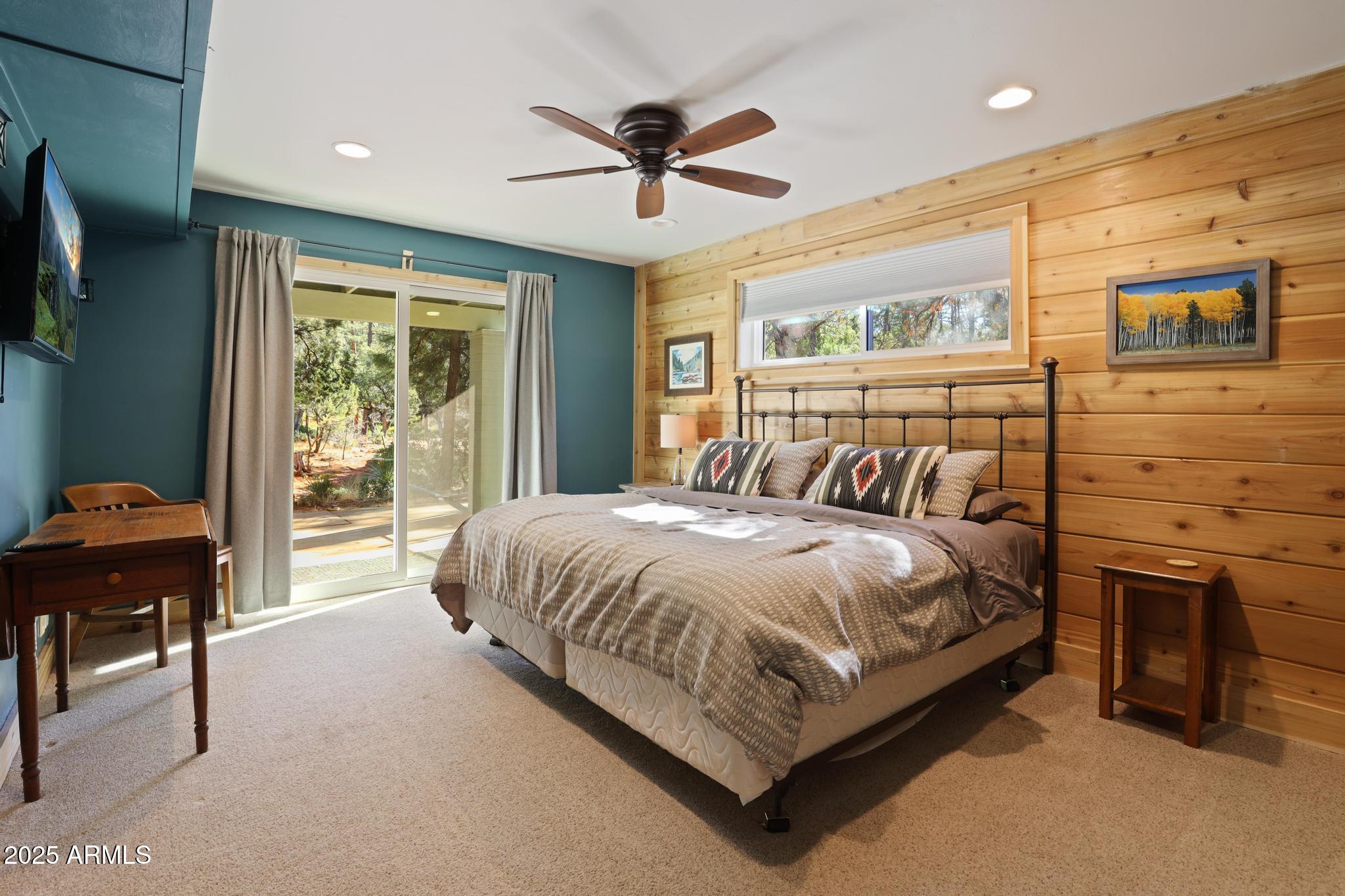 4744 Charles Circle Strawberry, AZ 85544 - Photo 24 of 39 a bedroom with a bed and a chandelier