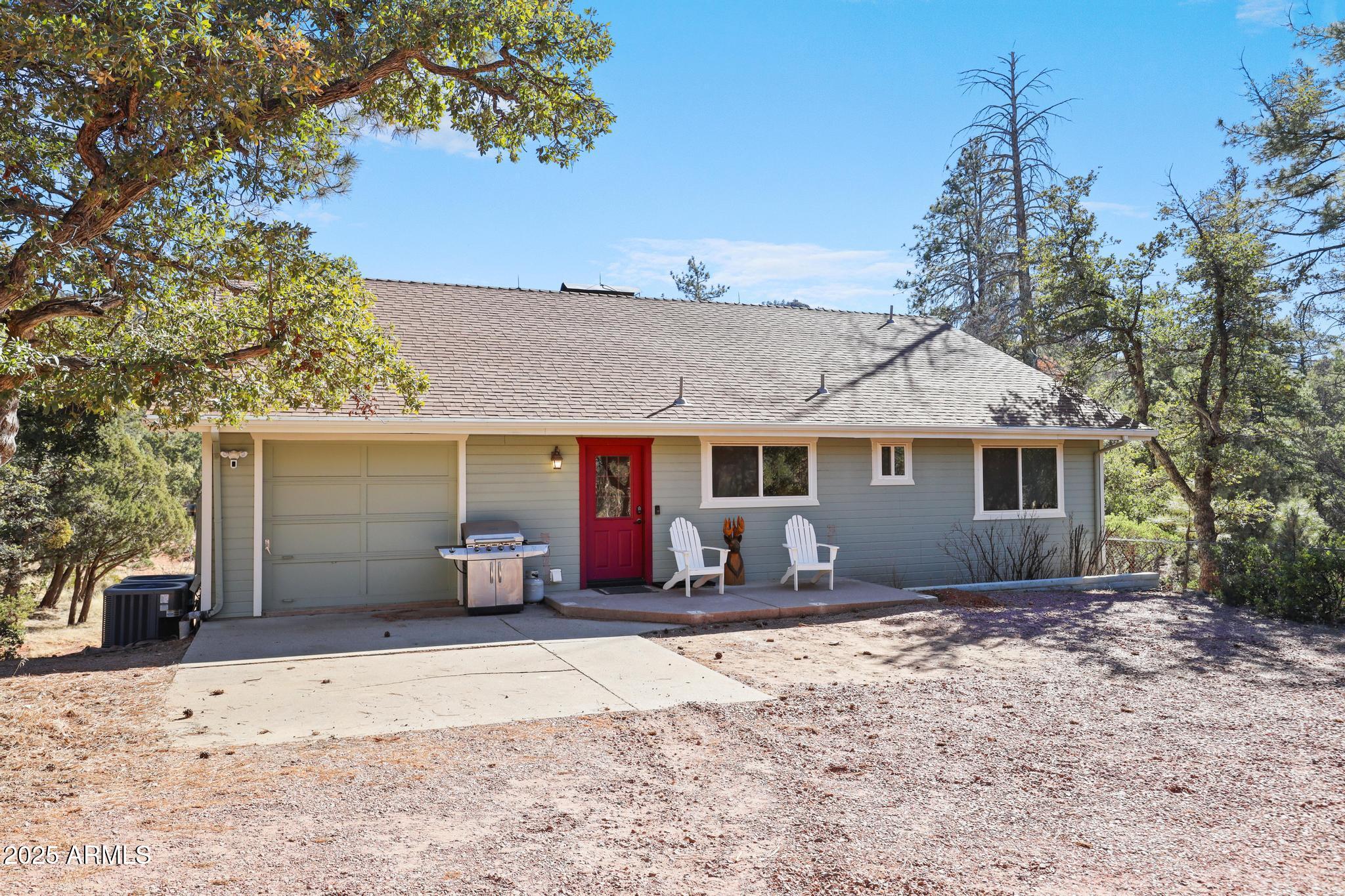 4744 Charles Circle Strawberry, AZ 85544 - Photo 3 of 39 a front view of a house with a yard and garage